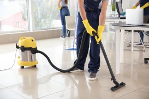 Janitor,Hoovering,Floor,In,Office